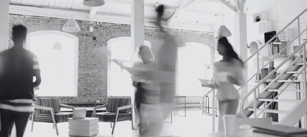 People at work in a bright loft studio office